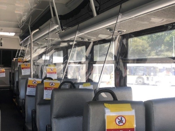 Interior of bus showing plastic guards between seats